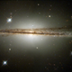 Illustration for article titled Why is this spiral galaxy all warped out of shape?